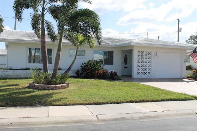 4460 95th Ave N Unit 1, Pinellas Park, FL 33782 - ranch-style house with an attached garage, a front yard, stucco siding, and decorative driveway