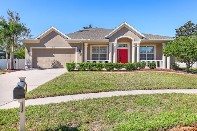 view of front of home with a front yard and a garage