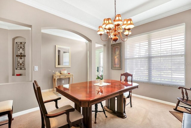 carpeted dining area with ornamental molding and an inviting chandelier