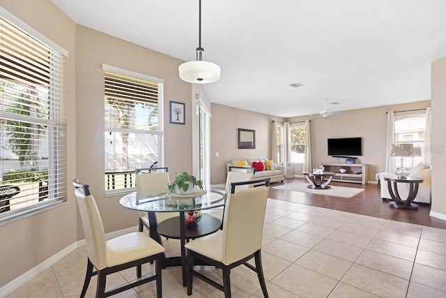 tiled dining space with ceiling fan