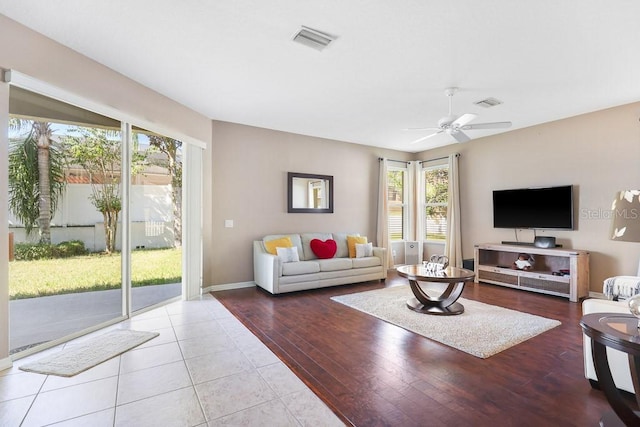 living room featuring light hardwood / wood-style floors and ceiling fan