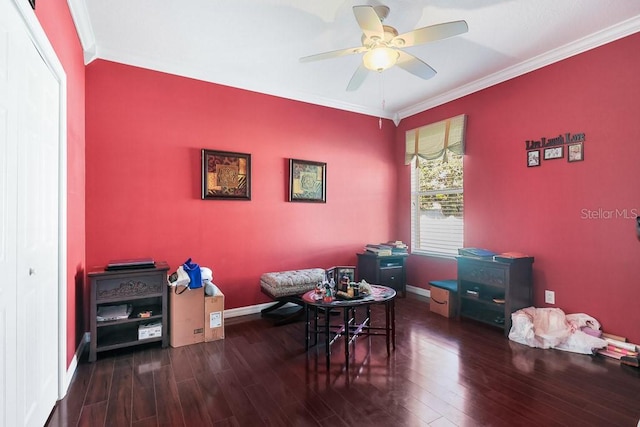 interior space with ornamental molding, dark wood-type flooring, and ceiling fan