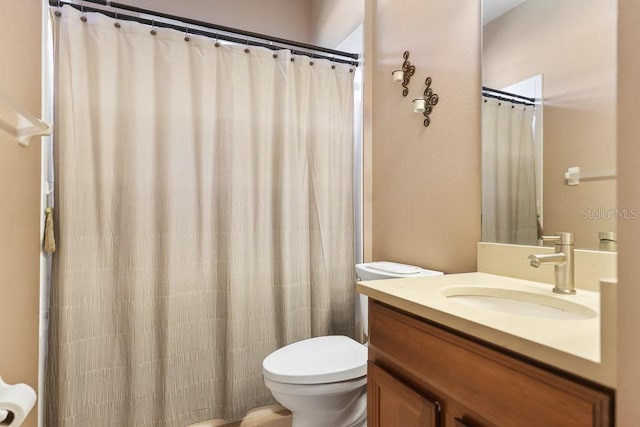 bathroom featuring vanity, toilet, and a shower with shower curtain