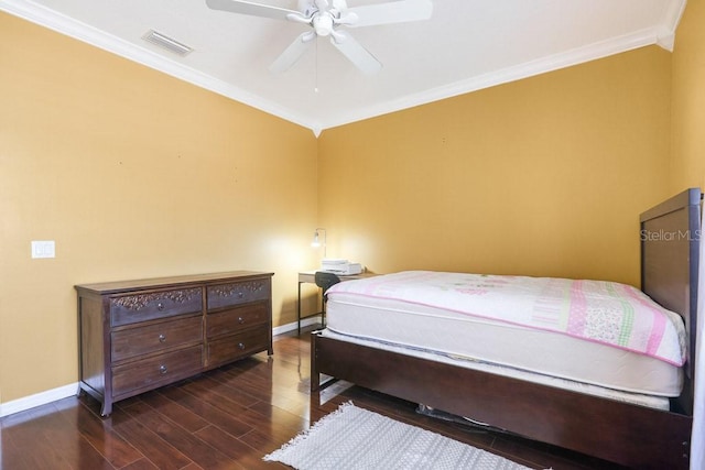 bedroom with dark wood-type flooring, ceiling fan, and ornamental molding