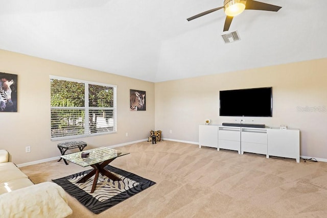 living room with vaulted ceiling, light colored carpet, and ceiling fan