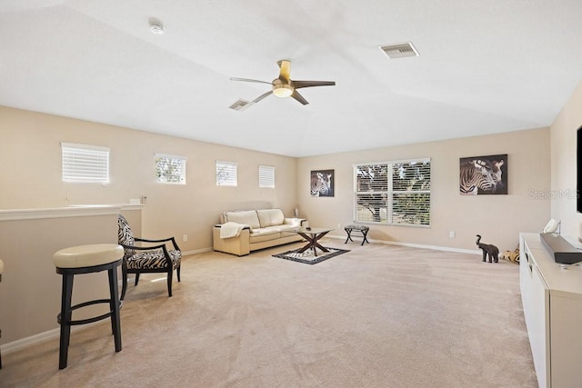 living room with light carpet, a healthy amount of sunlight, and ceiling fan