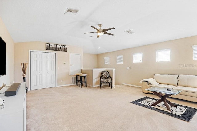 carpeted living room featuring ceiling fan and lofted ceiling