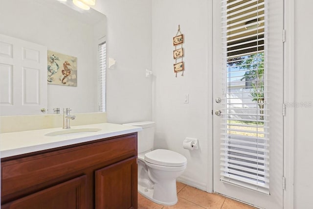 bathroom featuring vanity, toilet, and tile patterned floors