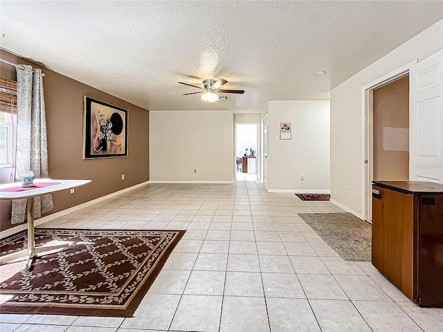 interior space with a textured ceiling and ceiling fan