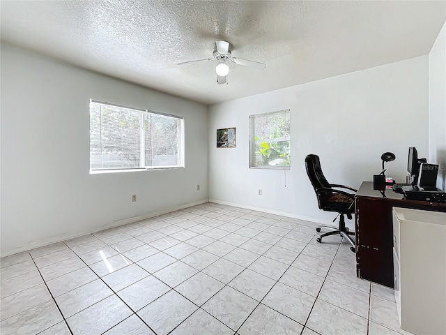 office space featuring a textured ceiling, light tile patterned floors, and ceiling fan