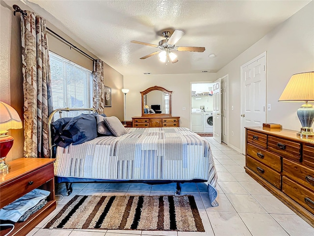 tiled bedroom featuring washer and dryer, a textured ceiling, and ceiling fan