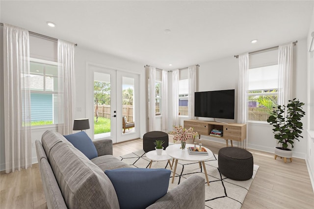 living area with recessed lighting, baseboards, french doors, and light wood finished floors