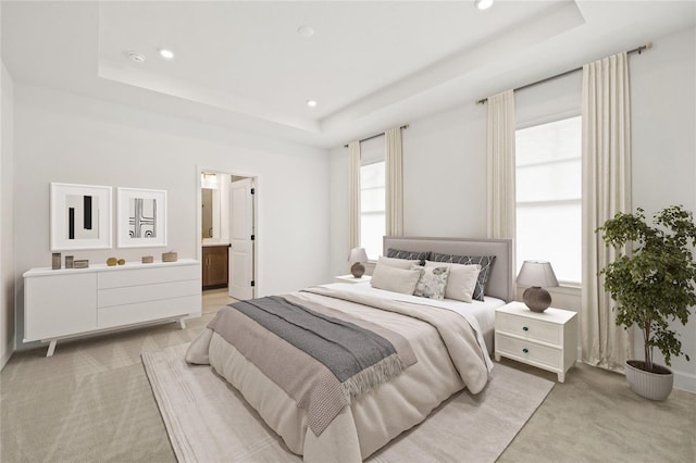 bedroom featuring a raised ceiling, light carpet, and recessed lighting