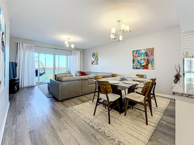 dining space featuring a chandelier and light hardwood / wood-style flooring