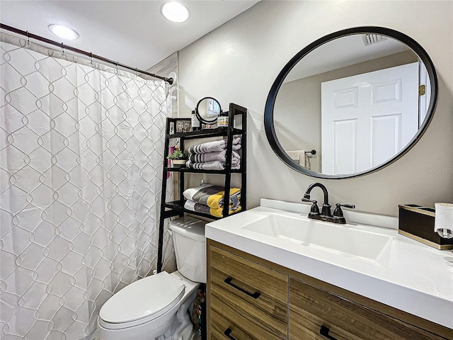 bathroom with vanity, toilet, and curtained shower