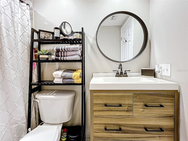 bathroom with vanity and toilet