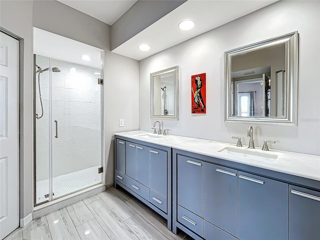 bathroom featuring vanity, a shower with shower door, and hardwood / wood-style floors