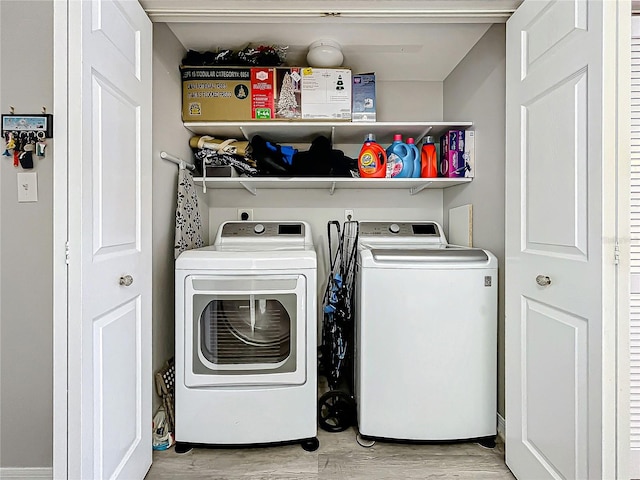 washroom featuring light hardwood / wood-style floors and washing machine and dryer