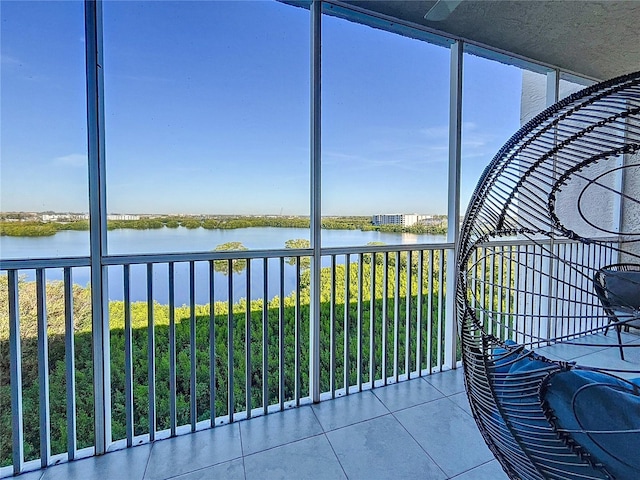 unfurnished sunroom featuring a healthy amount of sunlight and a water view