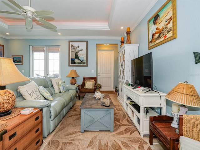 living room featuring crown molding, a raised ceiling, and ceiling fan