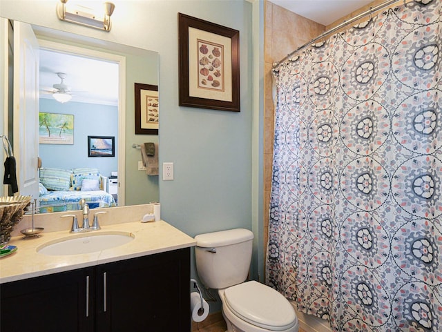 bathroom featuring vanity, curtained shower, toilet, and ceiling fan