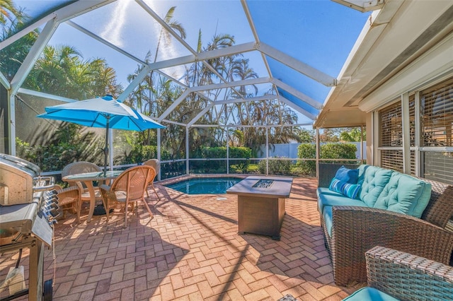 view of patio / terrace with a lanai and an outdoor living space with a fire pit