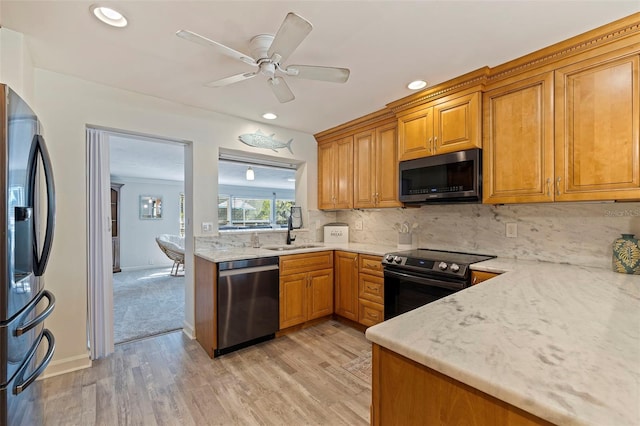 kitchen featuring ceiling fan, sink, light hardwood / wood-style flooring, and stainless steel appliances