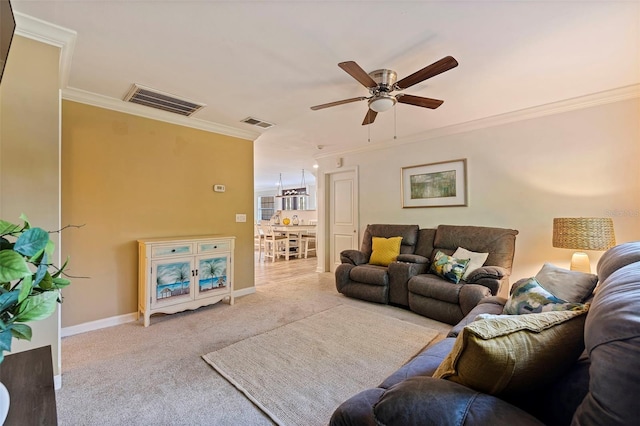 carpeted living room featuring ceiling fan and ornamental molding