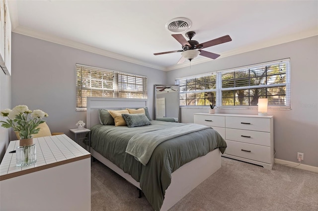 bedroom featuring light carpet, baseboards, visible vents, ceiling fan, and crown molding