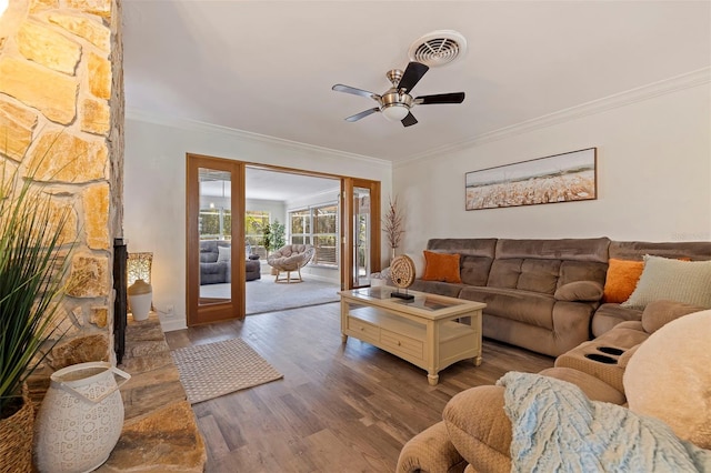 living room with visible vents, a ceiling fan, wood finished floors, crown molding, and french doors