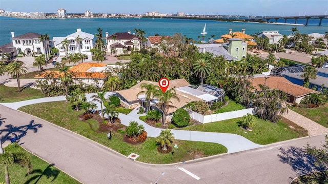 birds eye view of property with a water view and a residential view