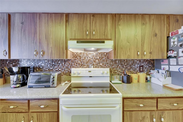 kitchen featuring white electric range and backsplash