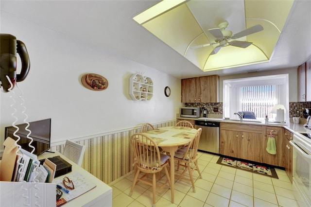 kitchen featuring light tile patterned floors, stainless steel appliances, tasteful backsplash, and sink