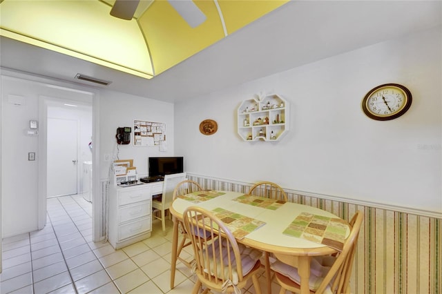 tiled dining area featuring built in desk and ceiling fan