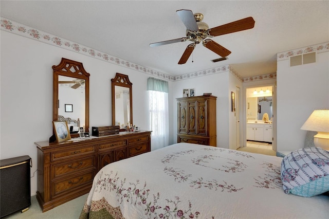 carpeted bedroom featuring ensuite bathroom and ceiling fan