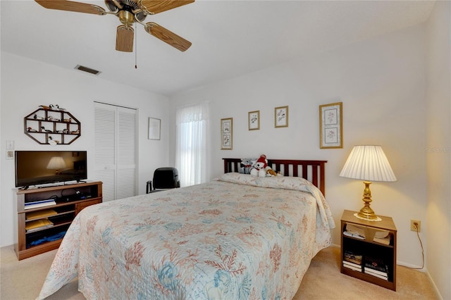 bedroom with light colored carpet, a closet, and ceiling fan