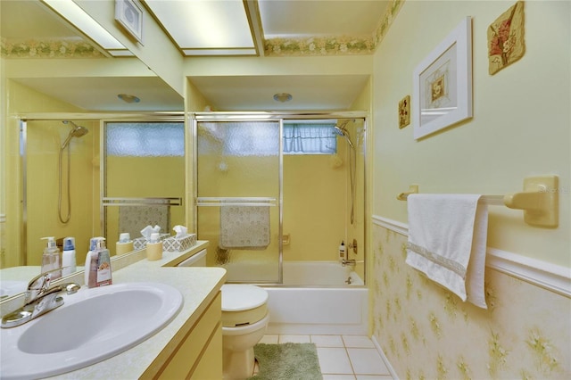 full bathroom featuring vanity, toilet, tile patterned floors, and shower / bath combination with glass door