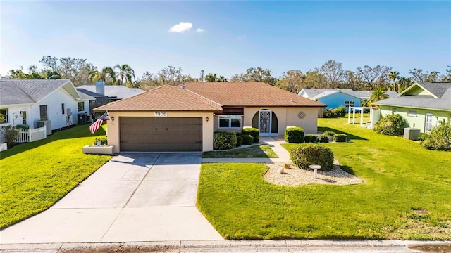 ranch-style home featuring a front lawn and a garage