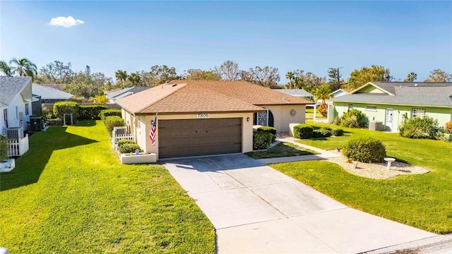 single story home featuring a garage and a front lawn