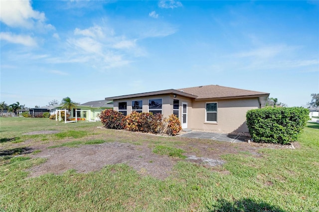 rear view of property with a lawn