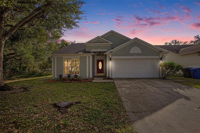 view of front of house with a lawn and a garage