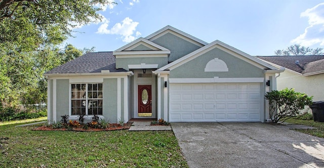 view of front of property featuring a garage and a front lawn