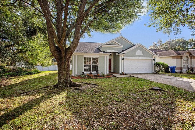 view of front of property featuring a garage and a front lawn