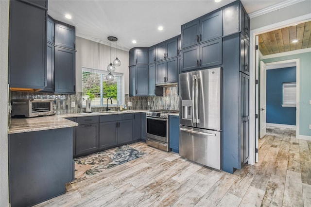 kitchen with light stone countertops, light hardwood / wood-style flooring, stainless steel appliances, sink, and decorative light fixtures