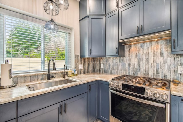 kitchen featuring gray cabinetry, sink, light stone counters, gas stove, and tasteful backsplash