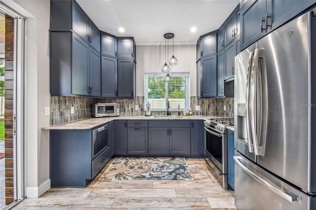 kitchen with sink, light stone counters, stainless steel appliances, and light wood-type flooring