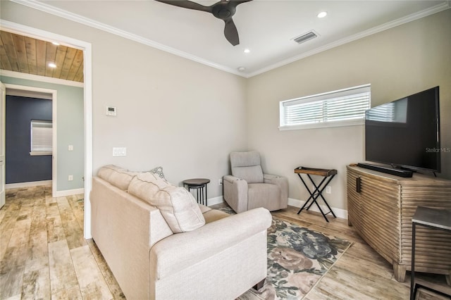 living area featuring ceiling fan, ornamental molding, and light wood-type flooring