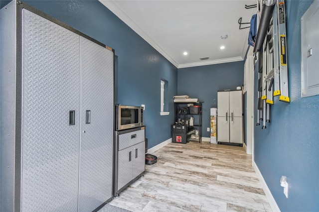 interior space with crown molding, water heater, and light wood-type flooring