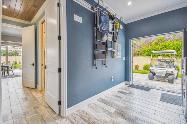 interior space featuring crown molding, light hardwood / wood-style flooring, and wooden ceiling