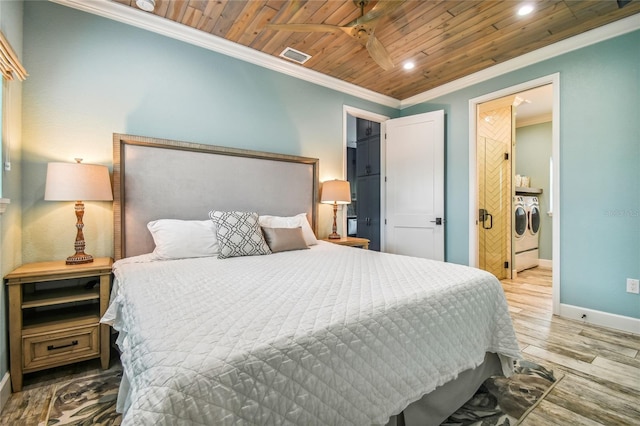 bedroom featuring independent washer and dryer, ornamental molding, wood ceiling, and light hardwood / wood-style floors